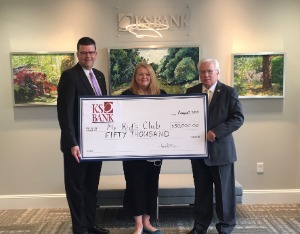 KS Employees and My Kid's Club Employee smiling with $50,000 check from bank